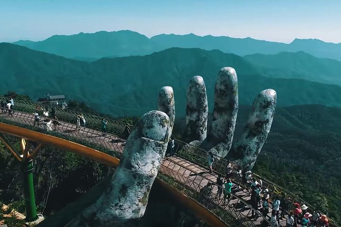 The Golden Bridge held up by two stone hands above Ba Na Hills